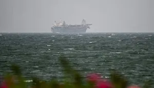 A vessel is seen off the coast of Sharjah in the United Arab Emirates on August 3, 2026. Iran's foreign ministry said on August 3 there were currently no negotiations with the United States but talks were taking place with Oman on management of the strategic Strait of Hormuz. Iran has kept control of Hormuz since the outbreak of the war in the Middle East on February 28. (Photo by AFP)/