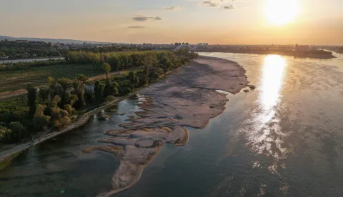 This aerial view shows sandbars appearing in the shallow water of the Danube River near Novi Sad, Serbia, on July 27, 2026. Scientists say global warming is increasing droughts and causing weather emergencies to become more extreme and more frequent. Prolonged drought and hot weather across Europe have pushed water levels along the Danube river to record seasonal lows, reaching its lowest flow rate in the last 30 years. (Photo by Nenad MIHAJLOVIC/AFP)