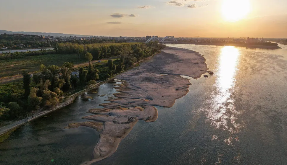 This aerial view shows sandbars appearing in the shallow water of the Danube River near Novi Sad, Serbia, on July 27, 2026. Scientists say global warming is increasing droughts and causing weather emergencies to become more extreme and more frequent. Prolonged drought and hot weather across Europe have pushed water levels along the Danube river to record seasonal lows, reaching its lowest flow rate in the last 30 years. (Photo by Nenad MIHAJLOVIC/AFP)