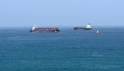 (FILES) A cargo ship is pictured off coast of the Khor Fakkan Container Terminal, the only natural deep-sea port in the region and one of the major container ports in Sharjah Emirate, along the Gulf of Oman on June 28, 2026. For 115 days, captain Mohammad Shafiqul Islam was stranded in the high seas of the Gulf, watching missiles light up the night sky and rationing food and water for his crew. "I tried to stay calm because I was responsible for 31 lives, a ship worth  million and cargo valued at .2 million," the 51-year-old Bangladeshi mariner told AFP, back home after the ordeal. (Photo by AFP)/