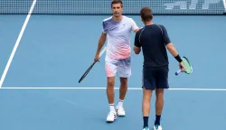 WASHINGTON, DC - AUGUST 02: Austin Krajicek of the United States and Nikola Mektic of Croatia high five during a men's doubles championship match against Julian Cash and Lloyd Glasspool of Great Britain on the final day of the Mubadala DC Open 2026 at William H.G. FitzGerald Tennis Center on August 02, 2026 in Washington, DC. Emilee Chinn/Getty Images/AFP (Photo by Emilee Chinn/GETTY IMAGES NORTH AMERICA/Getty Images via AFP)