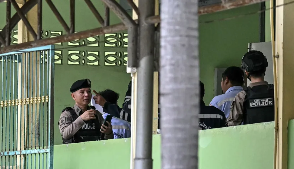 Police and emergency responders are pictured on the school premises following a shooting in Bang Kruai district, Nonthaburi province, north of Thailand's capital Bangkok, on August 7, 2026. At least four people were killed and 15 students injured during a school shooting just north of the Thai capital Bangkok on August 7, the deputy interior minister said. (Photo by Lillian SUWANRUMPHA/AFP)