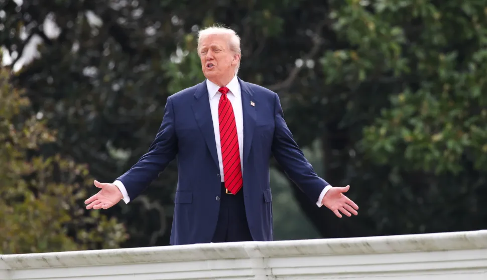 epa12284469 US President Donald J. Trump responds to a question from the news media as he tours the roof at the White House in Washington, DC, USA, 05 August 2025. President Trump has announced the construction of a new ballroom addition of approximately 90,000 total square feet of ornately designed and carefully crafted space, with a seated capacity of 650 people. EPA/SAMUEL CORUM/POOL