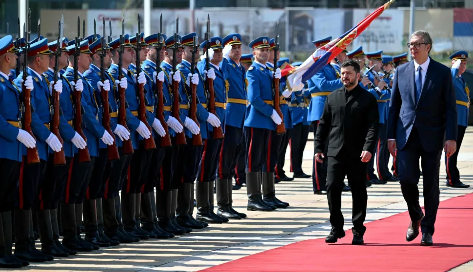 Serbia's President Aleksandar Vucic (R) and Ukraine's President Volodymyr Zelensky review the honour guard during a welcoming ceremony in front of the Palace of Serbia, in Belgrade on August 8, 2026. (Photo by Andrej ISAKOVIC/AFP)
