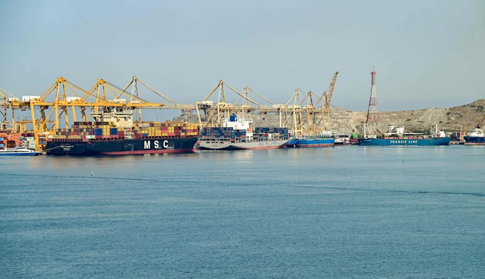 (L to R) The Liberia-flagged container vessel MSC Tasman VI, the Singapore-flagged container vessel Wan Hai 353, and other ships are docked along a pier at the Khor Fakkan Container Terminal, the only natural deep-sea port in the region and one of the major container ports in Sharjah Emirate, along the Gulf of Oman on June 19, 2026. Mediators in the US-Iran conflict, including Pakistan, Saudi Arabia and Turkey, are due to gather for talks in Egypt on June 21. A deal signed earlier in the week by US President Donald Trump and his Iranian counterpart Masoud Pezeshkian, aims to end the conflict that began on February 28 with US-Israeli strikes on Iran. It also provides for the reopening of the Strait of Hormuz and the launch of a 60-day negotiation period on broader issues, including Tehran's nuclear programme. (Photo by AFP)/