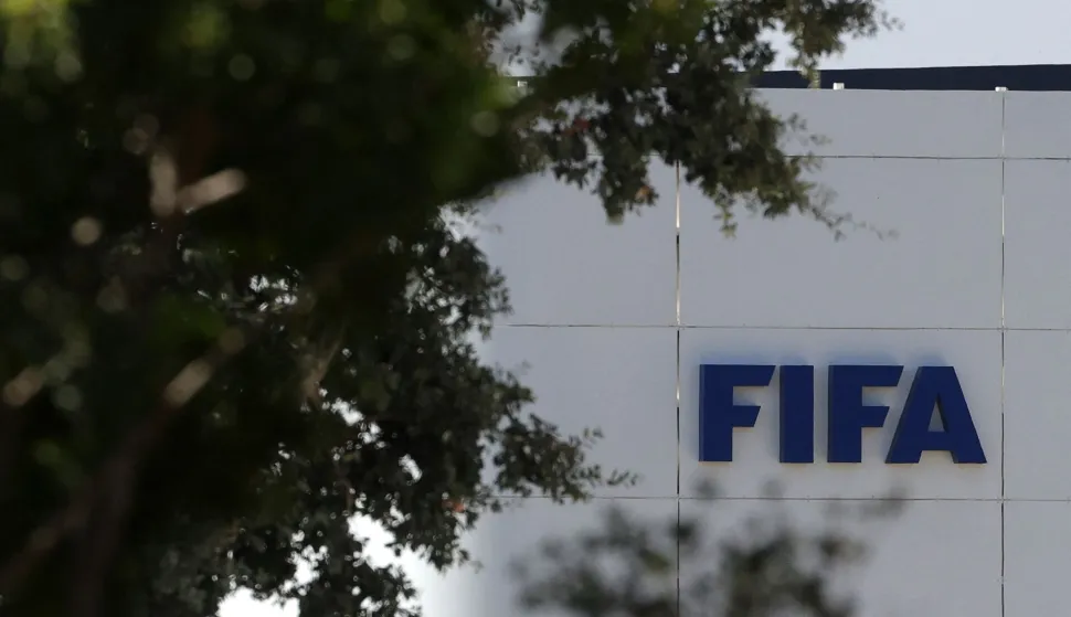 The FIFA logo is seen at its Africa regional office in Sale on August 5, 2026. President Gianni Infantino held emergency talks with other FIFA directors in Morocco on August 5, a source told AFP, amid a wave of criticism over his now shelved plan to open the World Cup to private investment. (Photo by Abdel Majid BZIOUAT/AFP)