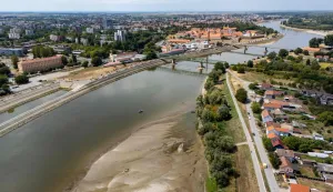 An aerial view shows a panorama of the city and an old ship (down, centre) exposed by receding water due to low water levels on the Drava River, in Osijek, Croatia, on August 8, 2026. (Photo by MARKO PERKOV/AFP)