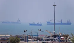 In this picture obtained from Iran's ISNA news agency on June 18, 2026, vessels are seen anchored in Bandar Abbas along the Strait of Hormuz. Oil prices tumbled after Trump and his Iranian counterpart separately signed their accord to end the Middle East war, with the Strait of Hormuz to reopen but two months of negotiations lying ahead. (Photo by AMIRHOSSEIN KHORGOOEI/ISNA/AFP)/