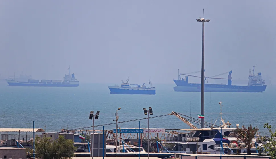In this picture obtained from Iran's ISNA news agency on June 18, 2026, vessels are seen anchored in Bandar Abbas along the Strait of Hormuz. Oil prices tumbled after Trump and his Iranian counterpart separately signed their accord to end the Middle East war, with the Strait of Hormuz to reopen but two months of negotiations lying ahead. (Photo by AMIRHOSSEIN KHORGOOEI/ISNA/AFP)/