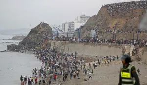 People gather along the fence at the site of clashes near Fnideq, on the Morocco-Spain border, on July 31, 2026. Thousands of migrants crossed overnight from Morocco into Spain's north Africa's Ceuta enclave, a police source said on July 31, as Prime Minister Pedro Sanchez was set to arrive to manage the latest migrant crisis on the border. (Photo by Abdel Majid BZIOUAT/AFP)