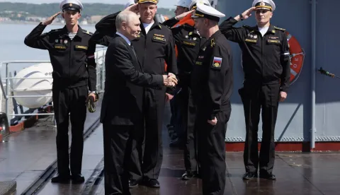 In this pool photograph distributed by the Russian state agency Sputnik, Russia's President Vladimir Putin visits the Russian Navy's guided missile cruiser Varyag as he oversees the final stage of a Pacific Fleet's naval drills on far eastern Sakhalin Island on August 12, 2026. (Photo by Gavriil Grigorov/POOL/AFP)