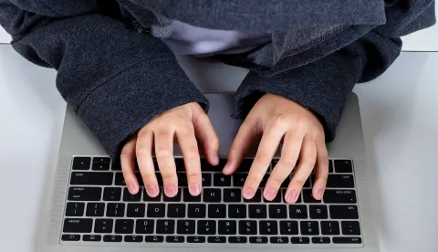 Top view and close up Asian hacker boy typing on laptop computer keyboard on with backgroundhaker laptop internet prijevare ilustracijafreepik
