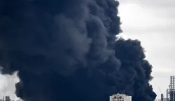 Black smoke rises from the area of the Russian oil producer Gazprom Neft's Moscow oil refinery on the south-eastern outskirts of Moscow on June 18, 2026. Moscow was fending off a "large-scale" drone attack from Ukraine, with several drones reaching an oil refinery, the city's mayor Sergey Sobyanin said early on June 18, 2026. (Photo by AFP)