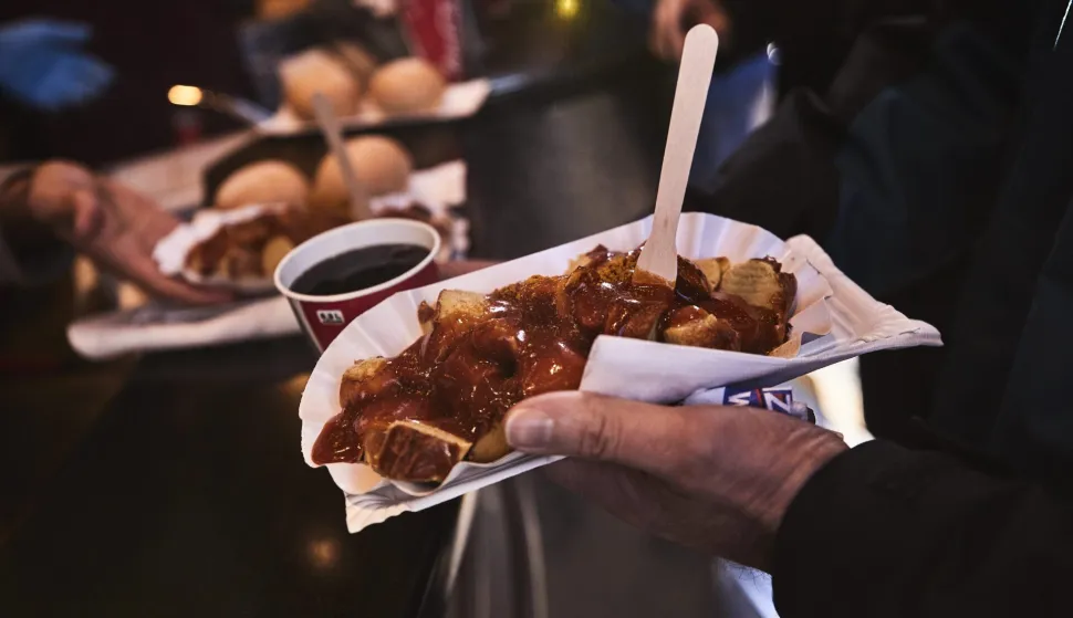 epa05722072 Customers pick up their ordered currywurst, sausages with a curry dip, at a Moe-Grill store in a shopping street in Hamburg, Germany, 16 January 2017. Moenke-Grill is a family business. It is operated in the second generation for 35 years. Approximately 3,000 sausages are sold per day at three different locations. A study by Greenpeace said almost half of Germans are eating less meat because of the environment. Forty-five percent of participants in the poll said they had reduced their meat consumption in a bid to limit their impact on the environment and climate change. EPA/CARSTEN KOALL