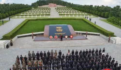 This picture taken on August 14, 2026 and released by North Korea's official Korean Central News Agency (KCNA) via KNS on August 15, 2026 shows North Korean leader Kim Jong Un (C) visiting the Taesongsan Revolutionary Martyrs Cemetery in Pyongyang, and laying flowers to mark the 81st anniversary of the end of World War II. (Photo by Handout/KCNA/AFP)/- South Korea OUT/---EDITORS NOTE--- RESTRICTED TO EDITORIAL USE - MANDATORY CREDIT "AFP PHOTO/KCNA VIA KNS" - NO MARKETING NO ADVERTISING CAMPAIGNS - DISTRIBUTED AS A SERVICE TO CLIENTSTHIS PICTURE WAS MADE AVAILABLE BY A THIRD PARTY. AFP CAN NOT INDEPENDENTLY VERIFY THE AUTHENTICITY, LOCATION, DATE AND CONTENT OF THIS IMAGE. THIS PHOTO IS DISTRIBUTED EXACTLY AS RECEIVED BY AFP./