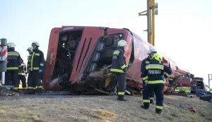 Rescue workers and other officials work at the wreckage of an overturned Polish tourist bus on the M3 motorway near Mezokeresztes, about 150 km east of the Hungarian capital Budapest, on August 16, 2026. A Polish bus overturned on a Hungarian highway early Sunday, August 16, 2026, killing 12 people and leaving at least 10 with serious injuries, Hungary's Prime Minister Peter Magyar and officials said. The coach, heading from Serbia to Poland, crashed at 1:00 am (2300 GMT Saturday) on the M3 highway near Mezokeresztes, east of Budapest, according to a police statement. (Photo by Zoltan MATHE/MTI/AFP)/Hungary OUT