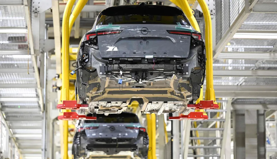 (FILES) Opel Astra passenger cars are transported automatically to their next production step at the company?s plant in Ruesselsheim, western Germany, on June 30, 2026. German carmaker Opel has long dominated the city of Ruesselsheim along the Rhine River, but in a sign of the times of Europe's struggling carmakers, the brand is turning to partnership with Chinese carmaker Leapmotor while slashing its own German engineering ranks. (Photo by Florian WIEGAND/AFP)