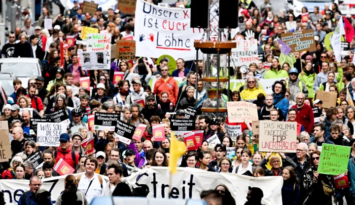 epa10695012 Protesters march during a demonstration of Fridays for Future calling for measures instead of a climate blockade in Berlin, Germany, 16 June 2023. EPA/FILIP SINGER