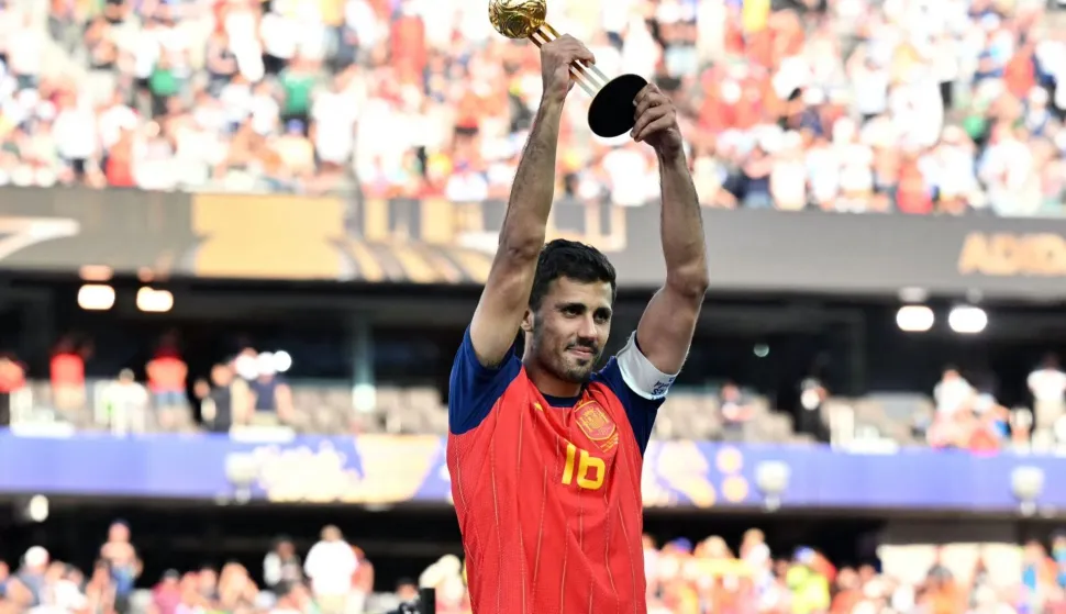 Spain's midfielder #16 Rodri lifts his most valuable player trophy at the end of the 2026 World Cup football tournament final match between Spain and Argentina at the New York/New Jersey Stadium in East Rutherford on July 19, 2026. (Photo by Mandel NGAN/AFP)