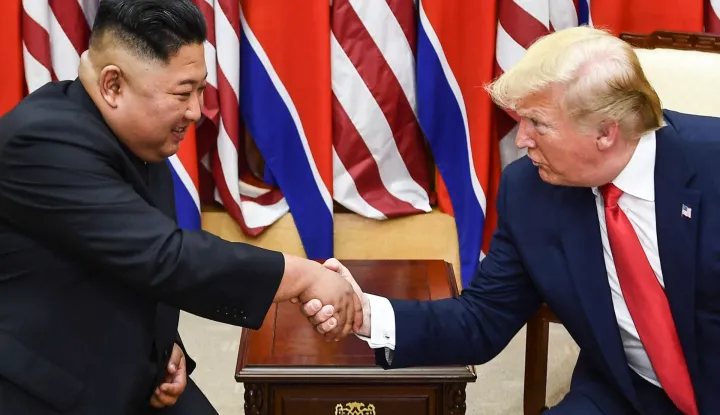 (FILES) North Korea's leader Kim Jong Un (L) and US President Donald Trump shake hands during a meeting on the south side of the Military Demarcation Line that divides North and South Korea, in the Joint Security Area (JSA) of Panmunjom in the Demilitarized zone (DMZ) on June 30, 2019. South Korea's defence ministry said August 17, 2026 that its joint military exercise with the United States has started after President Donald Trump's announcement it would be scaled back. Trump said he was "not happy" about US participation in the joint military exercises and is scaling back the drills aimed at deterring rival North Korea. (Photo by Brendan Smialowski/AFP)