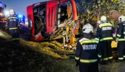 This handout picture received from Hungary's National Directorate General for Disaster Management, Ministry of the Interior (NDGDM), shows rescue workers and other officials working at the wreckage of an overturned Polish tourist bus on the M3 motorway near Mezokeresztes, about 150 km east of the Hungarian capital Budapest, on August 16, 2026. A Polish bus overturned on a Hungarian highway early Sunday, August 16, 2026, killing 12 people and leaving at least 10 with serious injuries, Hungary's Prime Minister Peter Magyar and officials said. The coach, heading from Serbia to Poland, crashed at 1:00 am (2300 GMT Saturday) on the M3 highway near Mezokeresztes, east of Budapest, according to a police statement. (Photo by David Dojcsak/NDGDM/AFP)/RESTRICTED TO EDITORIAL USE - MANDATORY CREDIT "AFP PHOTO/National Directorate General for Disaster Management, Ministry of the Interior (NDGDM)/David DOJCSAK- HANDOUT - NO MARKETING NO ADVERTISING CAMPAIGNS - DISTRIBUTED AS A SERVICE TO CLIENTS