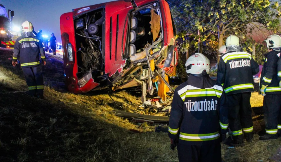This handout picture received from Hungary's National Directorate General for Disaster Management, Ministry of the Interior (NDGDM), shows rescue workers and other officials working at the wreckage of an overturned Polish tourist bus on the M3 motorway near Mezokeresztes, about 150 km east of the Hungarian capital Budapest, on August 16, 2026. A Polish bus overturned on a Hungarian highway early Sunday, August 16, 2026, killing 12 people and leaving at least 10 with serious injuries, Hungary's Prime Minister Peter Magyar and officials said. The coach, heading from Serbia to Poland, crashed at 1:00 am (2300 GMT Saturday) on the M3 highway near Mezokeresztes, east of Budapest, according to a police statement. (Photo by David Dojcsak/NDGDM/AFP)/RESTRICTED TO EDITORIAL USE - MANDATORY CREDIT "AFP PHOTO/National Directorate General for Disaster Management, Ministry of the Interior (NDGDM)/David DOJCSAK- HANDOUT - NO MARKETING NO ADVERTISING CAMPAIGNS - DISTRIBUTED AS A SERVICE TO CLIENTS