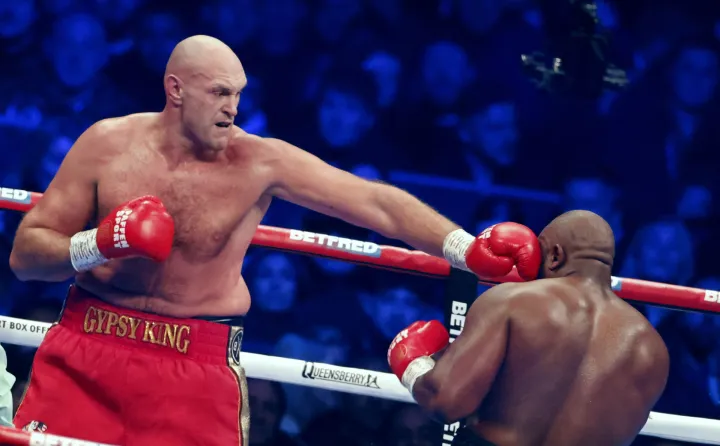 epa10347178 British boxer Tyson Fury (L) in action against British boxer Derek Chisora (R)during the bout between WBC heavyweight champion Tyson Fury and Derek Chisora at the Tottenham Hotspur stadium in London, Britain, 03 December 2022. EPA/TOLGA AKMEN