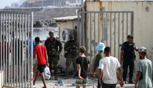Migrants cross the Ceuta-Morocco border gate in the Spanish North African enclave of Ceuta on August 1, 2026. At least 67 people have died in a recent surge of migrant crossings from Morocco to Spain's North African enclave of Ceuta, Spain's Interior Minister said today. Most of the 60,000 migrants who entered Ceuta over the space of a few days from neighbouring Morocco have already returned to Morocco. (Photo by Henry NICHOLLS/AFP)