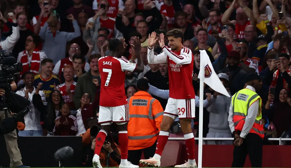 Arsenal's German midfielder #29 Kai Havertz celebrates scoring the team's first goal with Arsenal's English midfielder #07 Bukayo Saka during the English Premier League football match between Arsenal and Coventry City at the Emirates Stadium in London on August 21, 2026. (Photo by Henry NICHOLLS/AFP)/RESTRICTED TO EDITORIAL USE. No use with unauthorized audio, video, data, fixture lists, club/league logos or 'live' services. Online in-match use limited to 120 images. An additional 40 images may be used in extra time. No video emulation. Social media in-match use limited to 120 images. An additional 40 images may be used in extra time. No use in betting publications, games or single club/league/player publications./