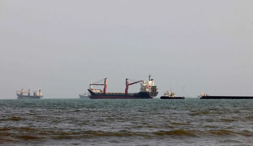 Vessels are seen in the Strait of Hormuz, off the port city of Bandar Abbas in southern Iran on August 10, 2026. The US President signalled on August 9 that he was prepared to let economic pressure mount against Iran, apparently backing away from more military strikes after Tehran issued a list of demands for opening the Strait of Hormuz. His remarks came after Iran issued over the weekend a list of conditions to reopen the Strait of Hormuz, which has remained largely closed since the start of the Middle East war in late February. (Photo by Atta KENARE/AFP)/