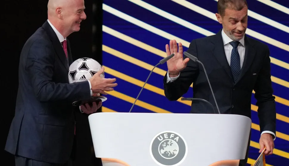 (FILES) FIFA President Gianni Infantino (L) speaks with UEFA president Aleksander Ceferin after addressing the 50th UEFA Ordinary Congress in Brussels on February 12, 2026. UEFA chief Aleksander Ceferin has ruled himself out of the running to replace Gianni Infantino, the under-fire FIFA president on August 24, 2026. Infantino has come under increasing pressure to step down over his now abandoned plan to secure private investment in FIFA tournaments, with Ceferin one of the leading figures in the challenge to him. (Photo by Pau BARRENA/AFP)