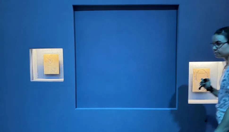 A blue panel covers the area where a display case was smashed and a Van Cleef and Arpels necklace was stolen at Vienna's Museum of Applied Arts (MAK), in Vienna, Austria, on August 28, 2026. Two men on August 27, 2026 bought tickets to enter Vienna's Museum of Applied Arts (MAK) before smashing a display case, grabbing a 200-carat platinum and diamond necklace and walking away, police said on August 28. Austrian media said the Van Cleef and Arpels necklace, with 673 precious stones, was worth several million dollars. It is the latest in a series of high-profile heists to hit European museums. (Photo by Jeremy AUDOUARD/AFP)