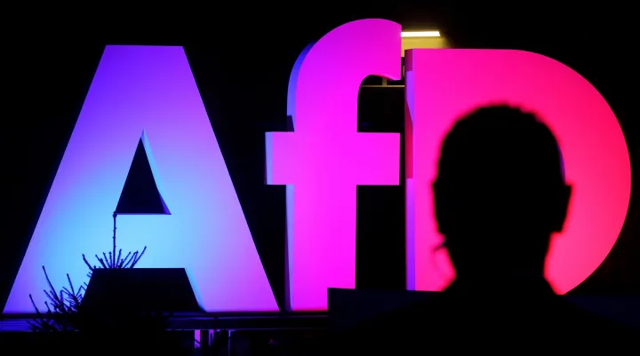 epa11919520 An illuminated AFD logo is seen at the Alternative for Germany (AfD) election event in Berlin, Germany, 23 February 2025. EPA/FILIP SINGER