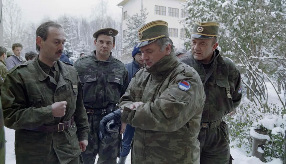 (FILES) Bosnian Serb General Ratko Mladic (2R) checks his watch at the Lukavica barracks in the surburbs of Sarajevo on February 15, 1994. Former Bosnian military Serb leader and war criminal Ratko Mladic has died in a prison hopsital in the Hague, according to Serbian state broadcaster RTS on August 27, 2026, after suffering several strokes. Mladic, 84, was dubbed the "Butcher of Bosnia" for his role in the 1995 Srebrenica massacre during the Bosnian war. (Photo by Pascal GUYOT/AFP)