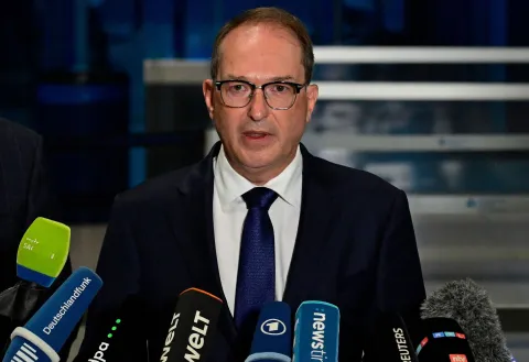 (FILES) German Interior Minister Alexander Dobrindt (C) addresses a press conference on August 5, 2026 at the German airport Leipzig-Halle in Schkeuditz, eastern Germany, after an explosives-laden drone was found near a Ukrainian cargo plane. Major German media reported on September 1, 2026 that the government would formally blame Russia for an incident involving an explosive-laden drone at the strategic airport. (Photo by John MACDOUGALL/AFP)