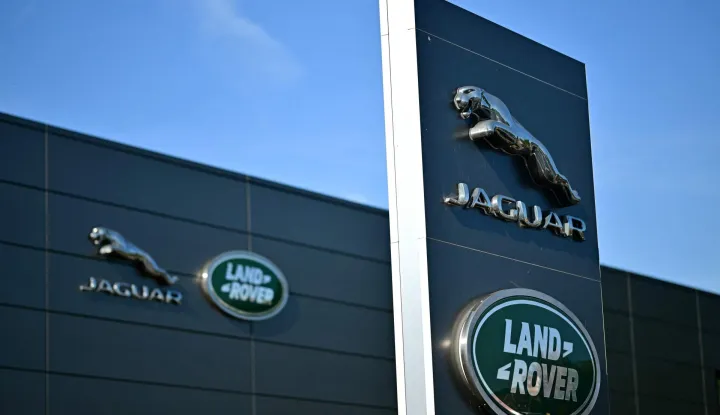 (FILES) Jaguar Land Rover signage is seen on a dealership in Tonbridge, south-east of London on September 29, 2025. British luxury carmaker Jaguar Land Rover announced on September 7, 2026 a voluntary redundancy scheme following months of turmoil caused by a cyberattack and US President Donald Trump's sector-wide tariffs. (Photo by Ben STANSALL/AFP)