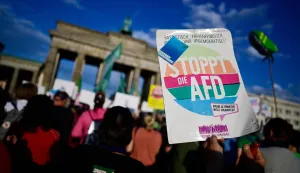 People protest during a rally called by the organizations Campact and Fridays for Future named ?Time to Act: Stop the AfD!" at the Brandenburg Gate in Berlin on September 7, 2026, one day after regional elections in the eastern federal state of Saxony-Anhalt. (Photo by John MACDOUGALL/AFP)