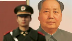 epa01173470 A Chinese paramilitary police officer stands on guard in front of the famous portrait of late paramount leader Mao Tse-tung at Tiananmen Gate in Beijing, China, 15 November 2007. China issued the first white paper on the nation's political party system 15 November 2007 reports state media. The document issued by the State Council of China refers to the nation's government as a 'multi-party cooperation system', fusing Marxism-Leninism with contemporary Chinese socialism. Critics such as international rights groups and foreign political parties claim that Beijing has an atrocious human rights record and that true leadership of the nation is firmly held by the Communist Party of China (CPC), not the eight other Chinese parties that have nominal power. EPA/MICHAEL REYNOLDS