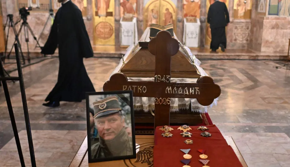 Mourners stands past the coffin of late Bosnian Serb military leader Ratko Mladic while taking part in a public memorial on the day of his funeral ceremony at St Lukas church in Belgrade, on September 7, 2026. Mladic, 84, died last week after suffering several strokes while serving a life sentence in The Hague for war crimes committed during the 1990s war in Bosnia. (Photo by OLIVER BUNIC/AFP)