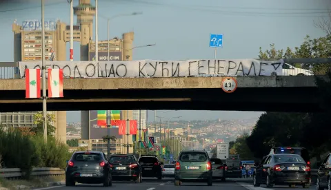 A banner reading "Welcome Home, General" is displayed on a footbridge over a motorway as a convoy carrying the body of Bosnian Serb war criminal Ratko Mladic passes through Belgrade, Serbia, on September 3, 2026. Mladic's body arrived in Serbia earlier in the day and was driven from the airport under police escort after being received with military honours. Mladic died the previous week while serving a life sentence for genocide, war crimes and crimes against humanity committed during the 1992-1995 Bosnian war. (Photo by Pedja MILOSAVLJEVIC/AFP)