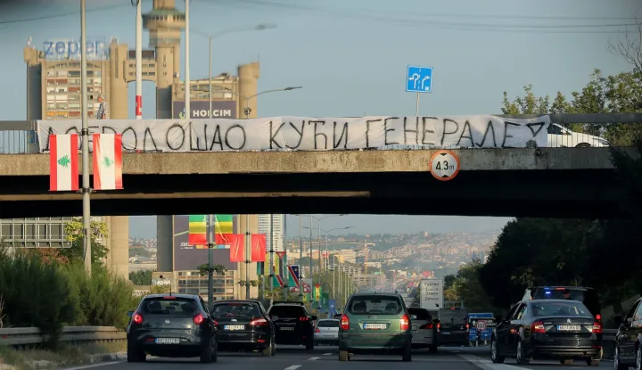 A banner reading "Welcome Home, General" is displayed on a footbridge over a motorway as a convoy carrying the body of Bosnian Serb war criminal Ratko Mladic passes through Belgrade, Serbia, on September 3, 2026. Mladic's body arrived in Serbia earlier in the day and was driven from the airport under police escort after being received with military honours. Mladic died the previous week while serving a life sentence for genocide, war crimes and crimes against humanity committed during the 1992-1995 Bosnian war. (Photo by Pedja MILOSAVLJEVIC/AFP)