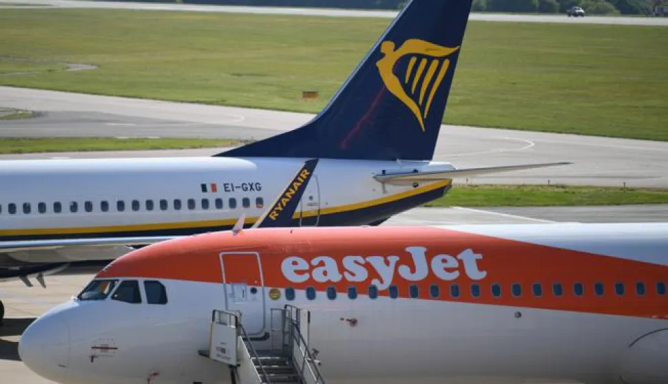 epa08397412 EasyJet and Ryanair aircraft are parked at Luton Airport, in Britain, 02 May 2020. Due to the coronavirus number UK daily flights has fallen and in some routes have been suspended. British Airways' parent company IAG announced it is set to cut up to 12,000 positions. Easyjet has laid off its 4,000 UK-based cabin crew for two months. Countries around the world are taking increased measures to stem the widespread of the SARS-CoV-2 coronavirus which causes the Covid-19 disease. EPA/NEIL HALL