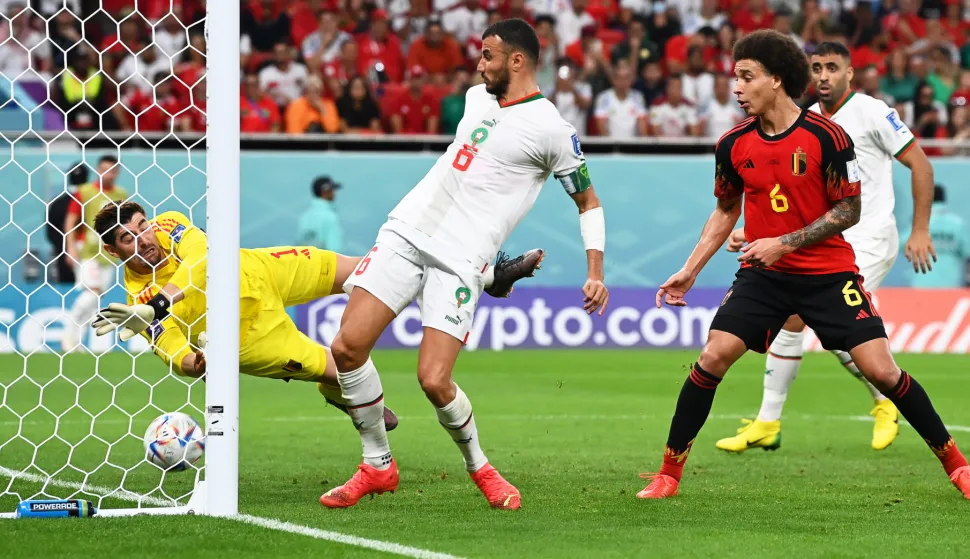 epa10332353 Belgium's goalkeeper Thibaut Courtois (L) concedes Morocco's 1-0 lead during the FIFA World Cup 2022 group F soccer match between Belgium and Morocco at Al Thumama Stadium in Doha, Qatar, 27 November 2022. EPA/Georgi Licovski