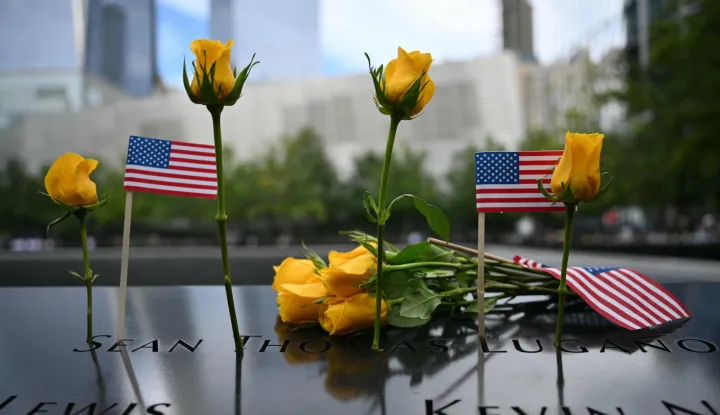 Flowers are left at the memorial during the 25th anniversary commemoration of the September 11, 2001 attacks at the National September 11 Memorial in New York on September 11, 2026. (Photo by ANGELA WEISS/AFP)