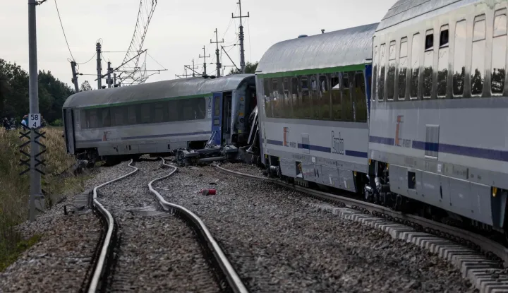 Damaged railway carriages are seen at the site where a passenger train collided with a lorry at a level crossing in the village of Sokolniki Suche, south-eastern Poland on September 9, 2026. A train carrying 120 passengers collided with a cement truck and derailed in east-central Poland, killing one passenger and leaving several injured, local authorities said Wednesday. (Photo by Wojtek RADWANSKI/AFP)VLAK, DRON