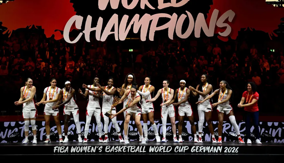USA's team celebrates with the trophy after the 2026 FIBA Women?s Basketball World Cup final game between the United States and France in Berlin on September 13, 2026. (Photo by Tobias SCHWARZ/AFP)