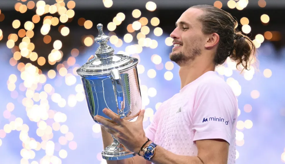 Germany's Alexander Zverev holds the trophy after defeating USA's Ben Shelton in the men's singles final tennis match on day fifteen of the US Open tennis tournament at the USTA Billie Jean King National Tennis Center in New York on September 13, 2026. (Photo by ANGELA WEISS/AFP)