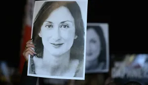 (FILES) Protesters hold pictures of the late journalist Daphne Caruana Galizia as they gather outside the prime minister's office to call for his resignation, in Valletta, Malta on November 20, 2019, the day Maltese businessman Yorgen Fenech, who is believed to be the mastermind behind her assassination, was detained on his yacht after he tried to leave Malta. A Maltese court on September 2, 2026 aquitted tycoon Yorgen Fenech of orchestrating the brutal murder in 2017 of investigative reporter Daphne Caruana Galizia, according to media reports. (Photo by Matthew Mirabelli/AFP)