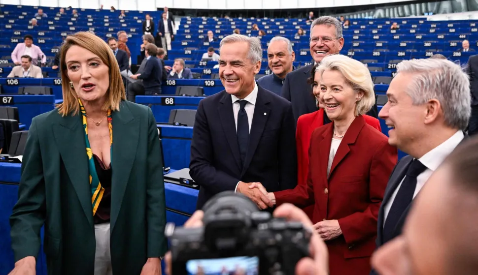 Canadian Prime Minister Mark Carney (C) shakes hands with European Commission President Ursula von der Leyen (2ndR), next to European Parliament President Roberta Metsola (L), in Strasbourg, eastern France, on September 17, 2026. Canadian Prime Minister Mark Carney on September 17, 2026, rejected threats by US President Donald Trump over Ottawa's push for closer ties with the European Union. (Photo by Jean-Christophe VERHAEGEN/AFP)