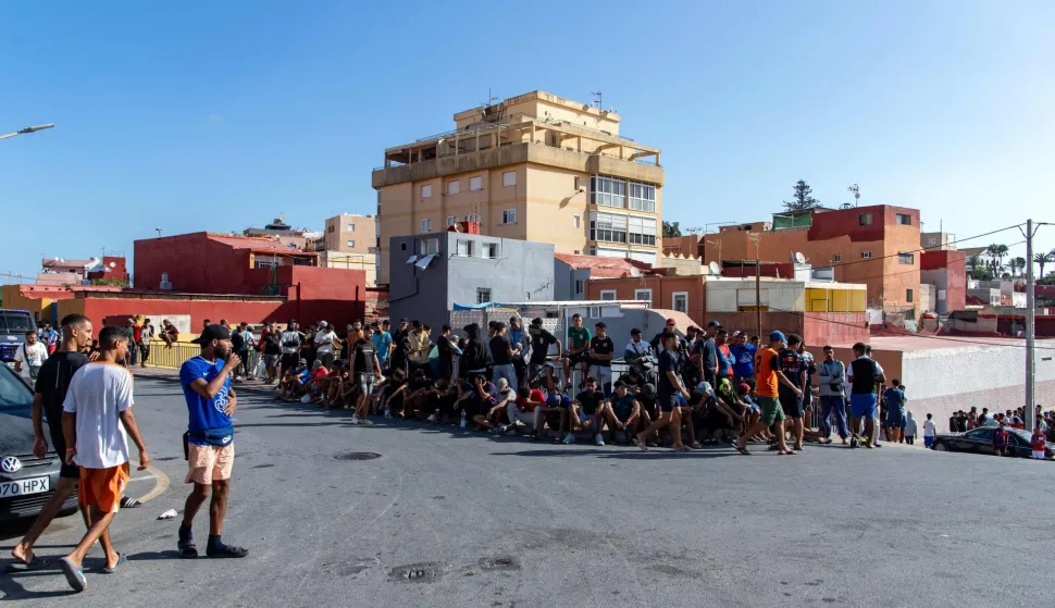 Unadmitted migrants wait outside the new Los Rosales migrant reception camp, where more than 800 people have been transferred from the Loma Colmenar camp, in Ceuta, on September 12, 2026. More than 70,000 migrants streamed into Ceuta from neighbouring Morocco on July 30 and 31, in an unprecedented rush that left scores dead. Thousands remain in the small city, increasing tensions with increasingly frustrated locals who demand their expulsion and a return to normality. The crisis has generated a constant churn of negative headlines and dominated the political debate for six weeks. (Photo by Antonio Sempere/AFP)